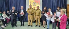 Na zdjęciu widzimy komendanta KP PSP w Pruszczu Gdańskim oraz innych gości i członków komisji Ogólnopolskiego Turnieju Wiedzy Pożarniczej oklaskujących uczestników eliminacji.