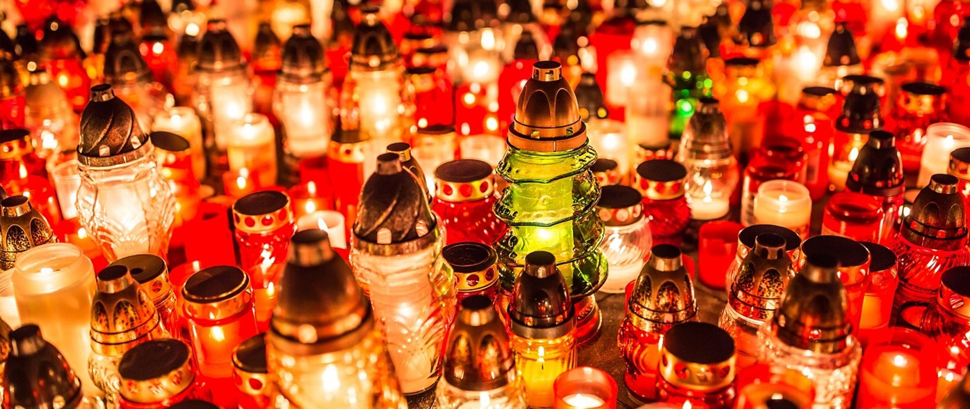 Many burning candles in the cemetery at night on the occasion souls of the deceased.