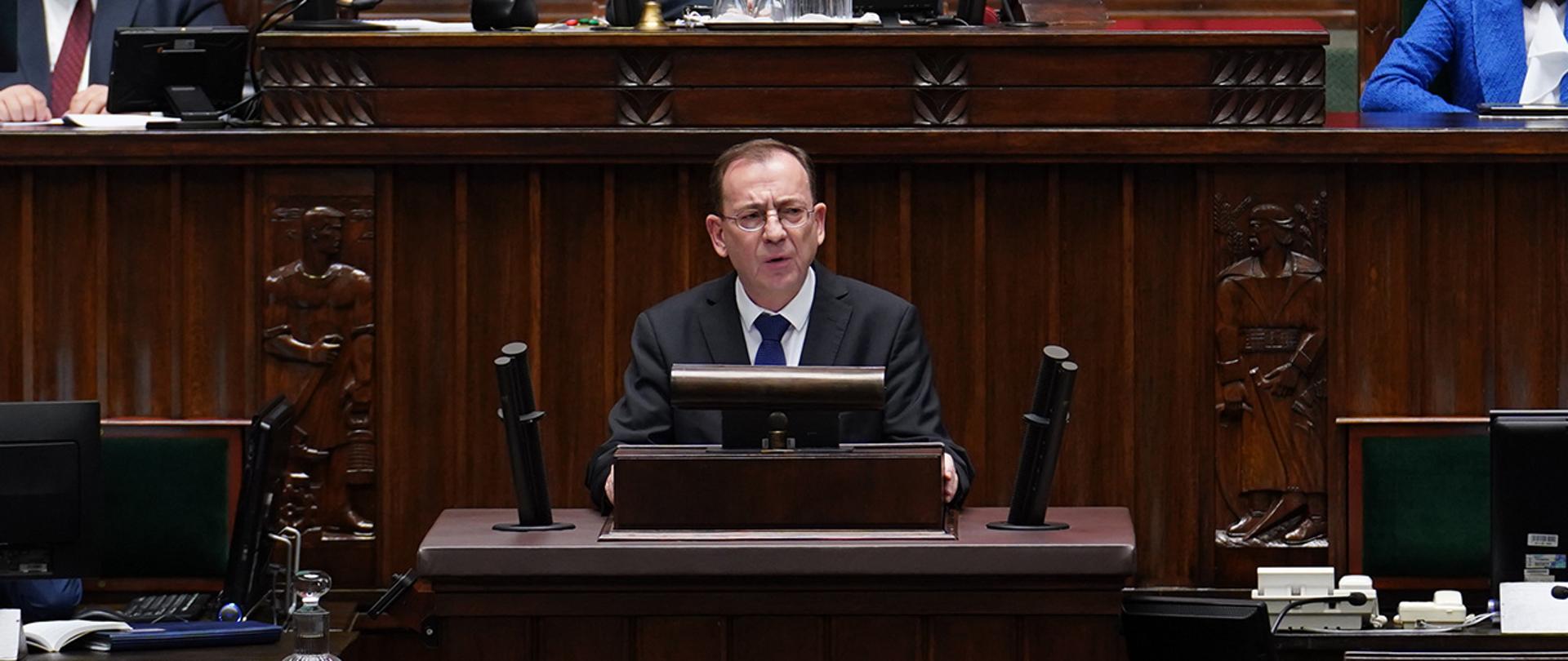 Minister Mariusz Kamiński podczas wystąpienia przy mównicy sejmowej.