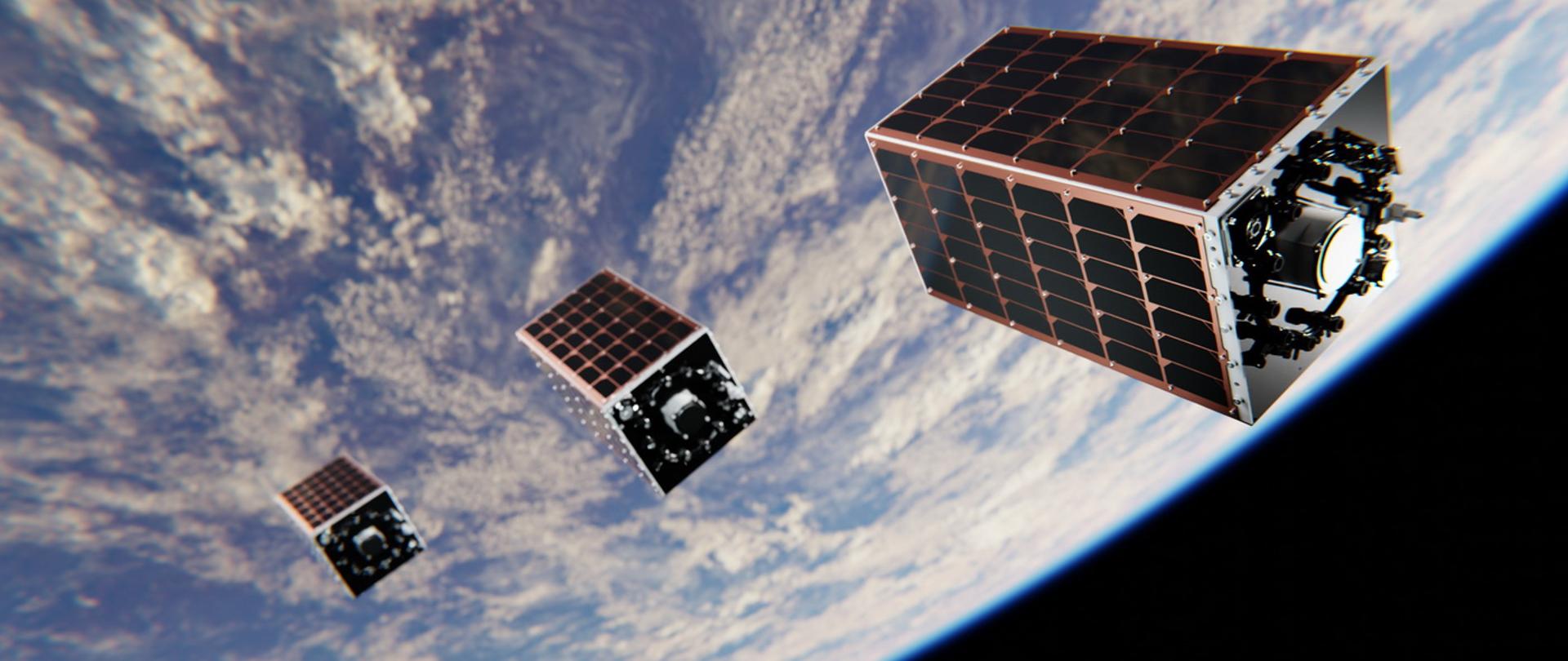 Grafika - na tle kuli ziemskiej trzy czworokątne pudełkowate satelity, źródło - Instytut Lotnictwa