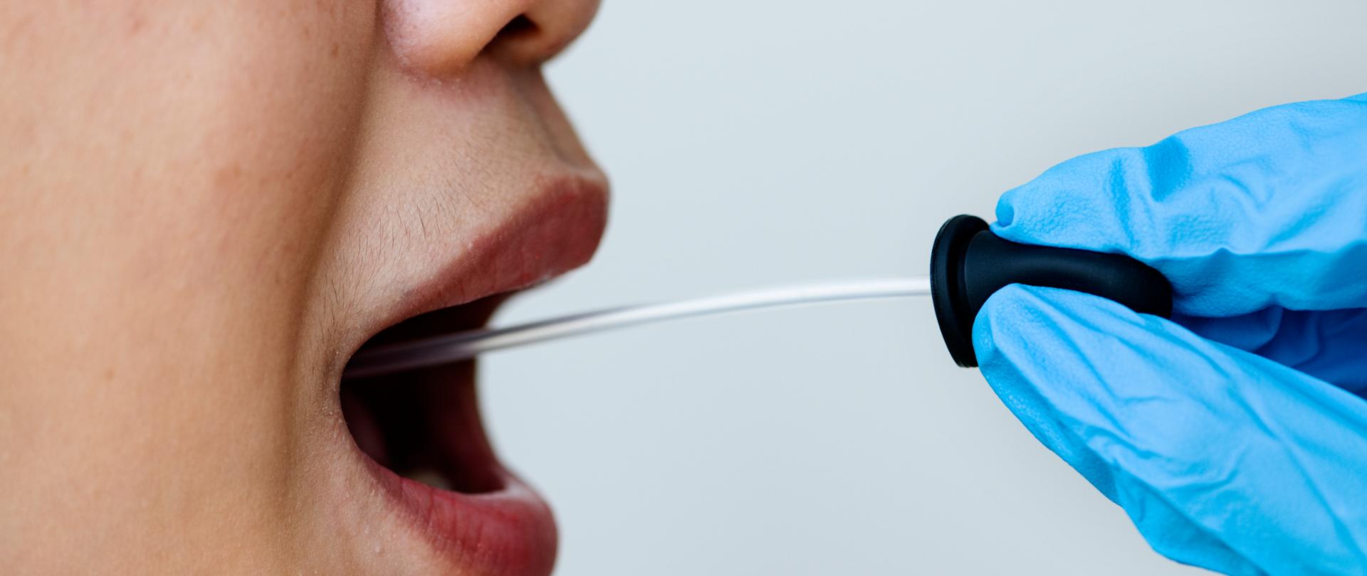 Woman getting a mouth swab to test for coronavirus