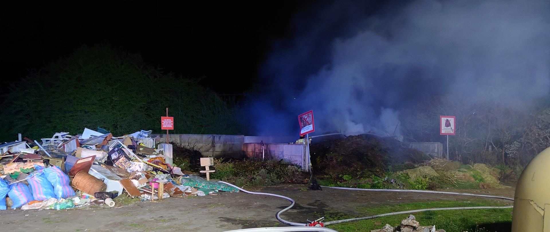 Zdjęcie w porze nocnej. Widać pozostałości roślinne. Nad pozostałościami zadymienie i para wodna. Światło sztuczne.