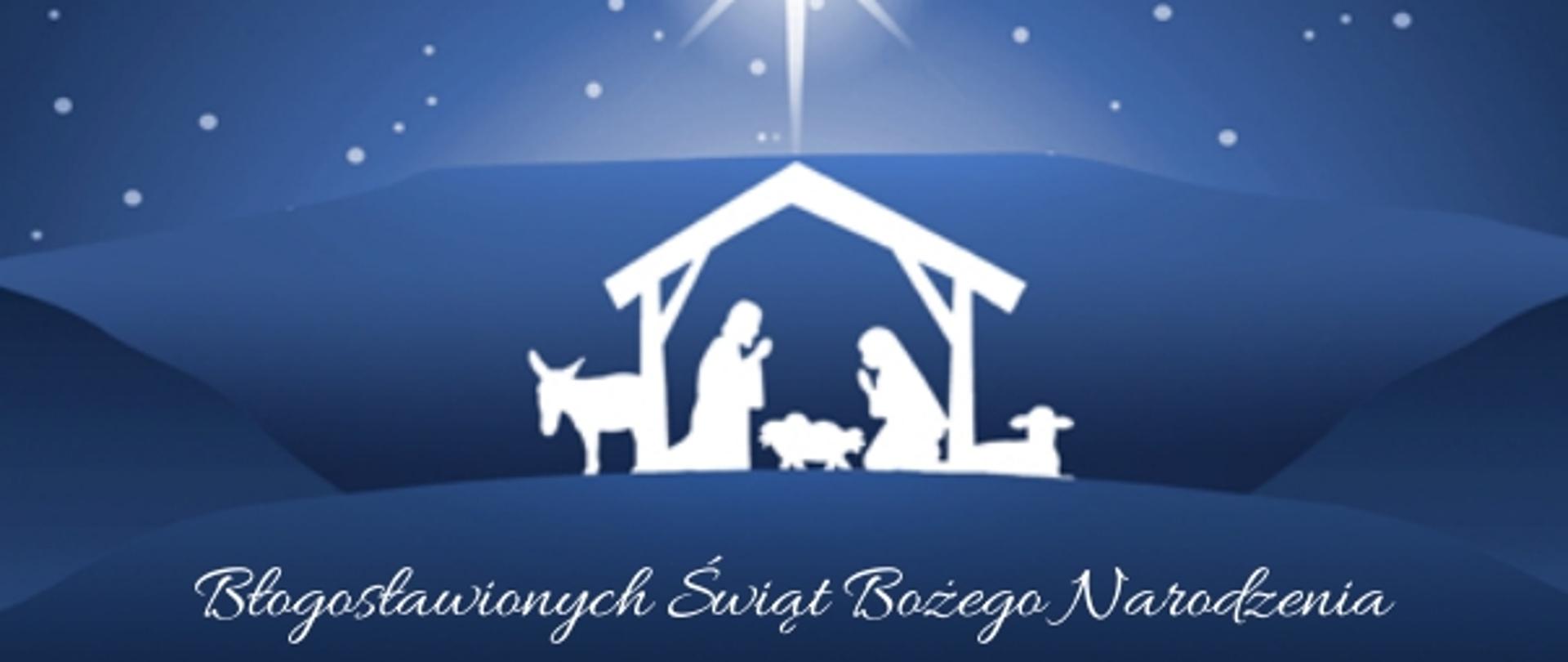 Zdjęcie przedstawia grafikę bożonarodzeniową. Widoczny zarys szopki z klęczącym świętym Józefem i Maryją. Pośrodku mały żłobek. Obok szopki stoją osioł i baranek. Nad szopką widać niebo pełne gwiazd, w centrum duża jasna gwiazda betlejemska.