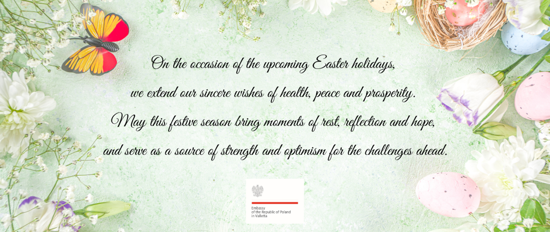 Black Easter wishes text on a green background, framed by flowers, butterflies and decorated eggs.