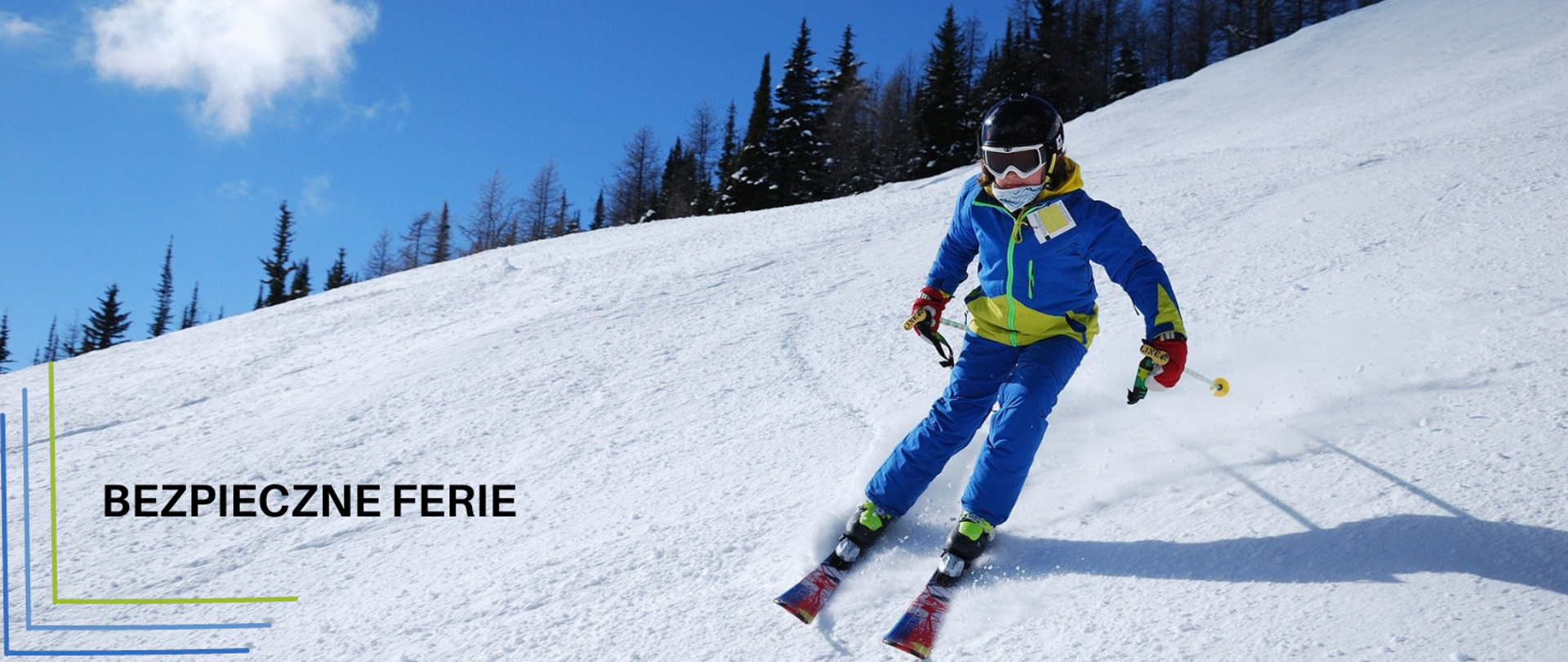 Narciarz w niebieskim kombinezonie zjeżdżający na nartach