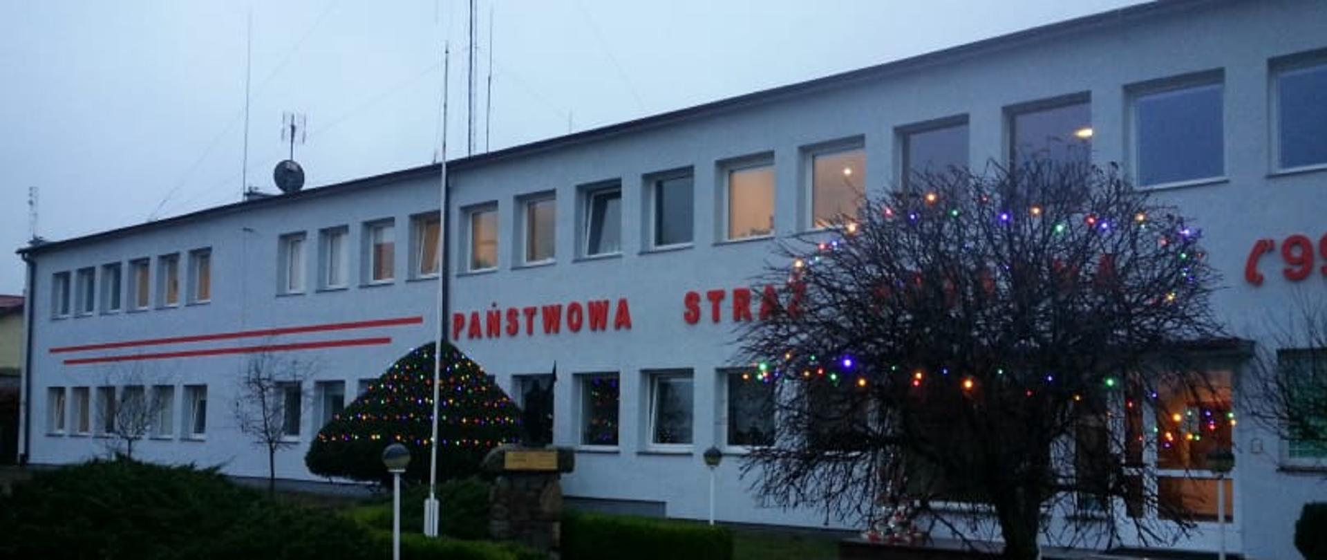 Zdjęcie przedstawia świeżo odremontowany budynek KP PSP Świdwin. Elewacja budynku pomalowana jest na jasny szary kolor. 