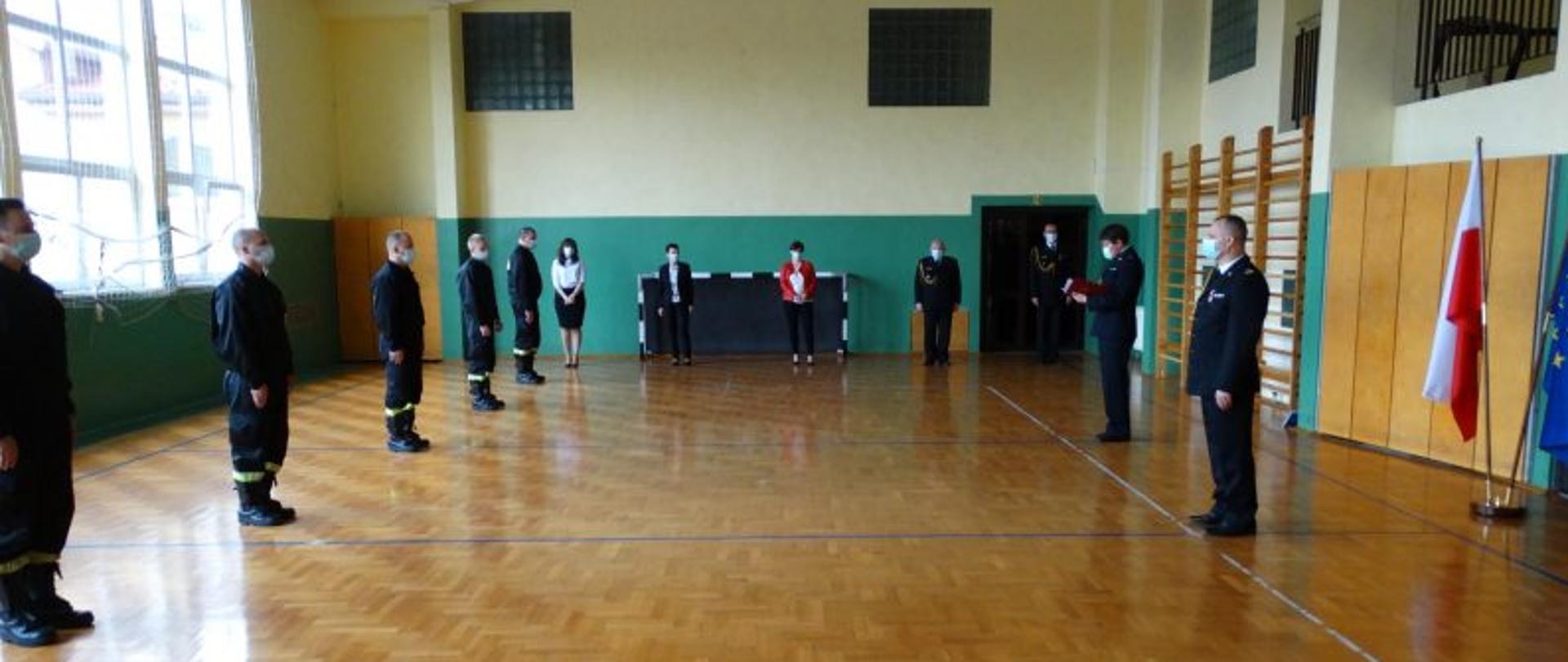 Zdjęcie wykonano na sali gimnastycznej w PSP w Jaśle pracownicy komendy wraz z komendantem oraz strażacy awansowani z JRG Jasło
