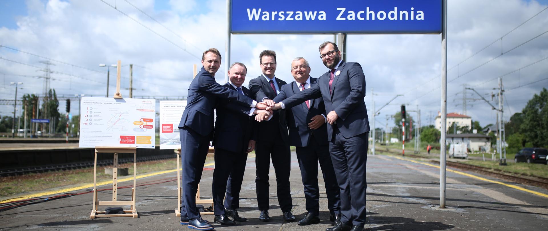 Na peronie stacji Dworca Warszawa Zachodnia stoi grupa mężczyzna wśród nichwiceminister Grzegorz Puda.