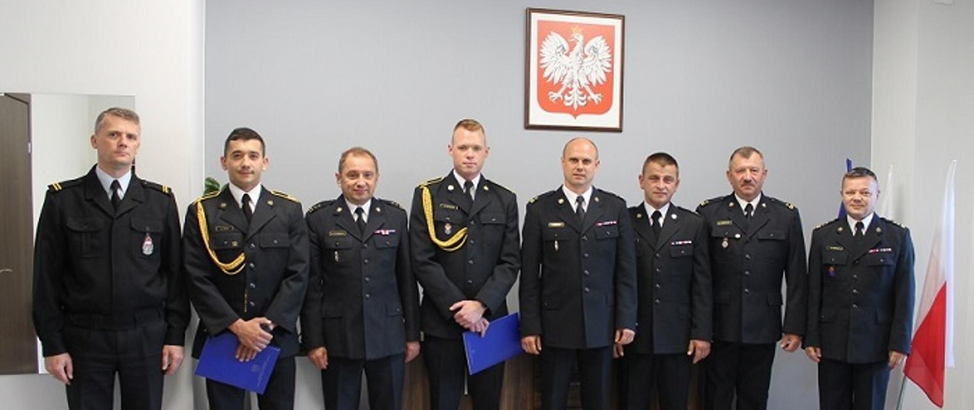 Wspólne zdjęcie funkcjonariuszy podczas uroczystości, która odbyła się w sali odpraw komendy powiatowej Państwowej Straży Pożarnej w Mielcu.