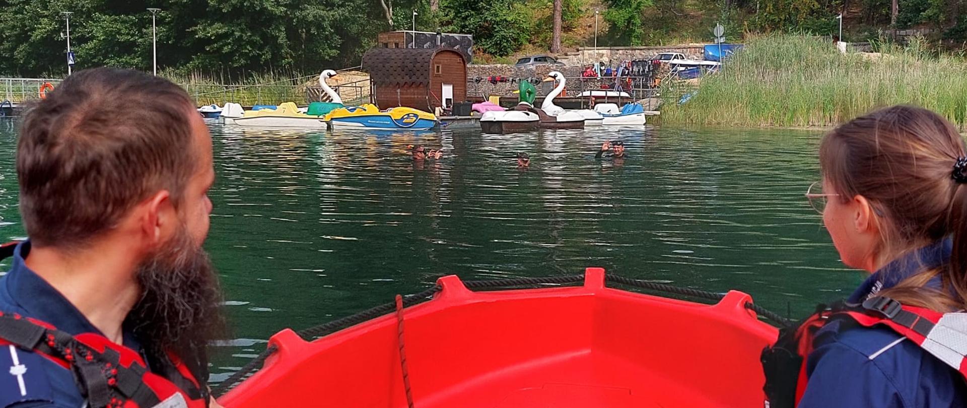 Na zdjęciu widnieją strażacy wraz z policjantami, którzy dokonują wspólnego patrolu na obszarze wodnym. 