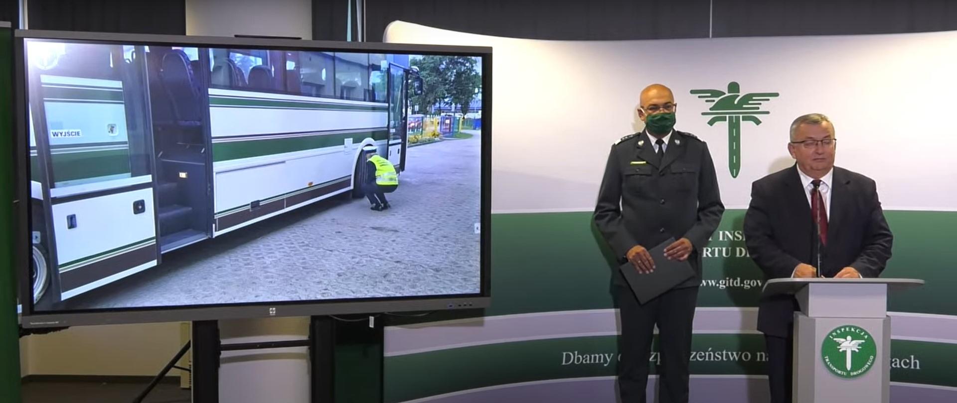Od lewej: monitor, na którym wyświetlany jest film z kontroli autobusu szkolnego, Główny Inspektor Transportu Drogowego Alvin Gajadhur i Minister Infrastruktury Andrzej Adamczyk