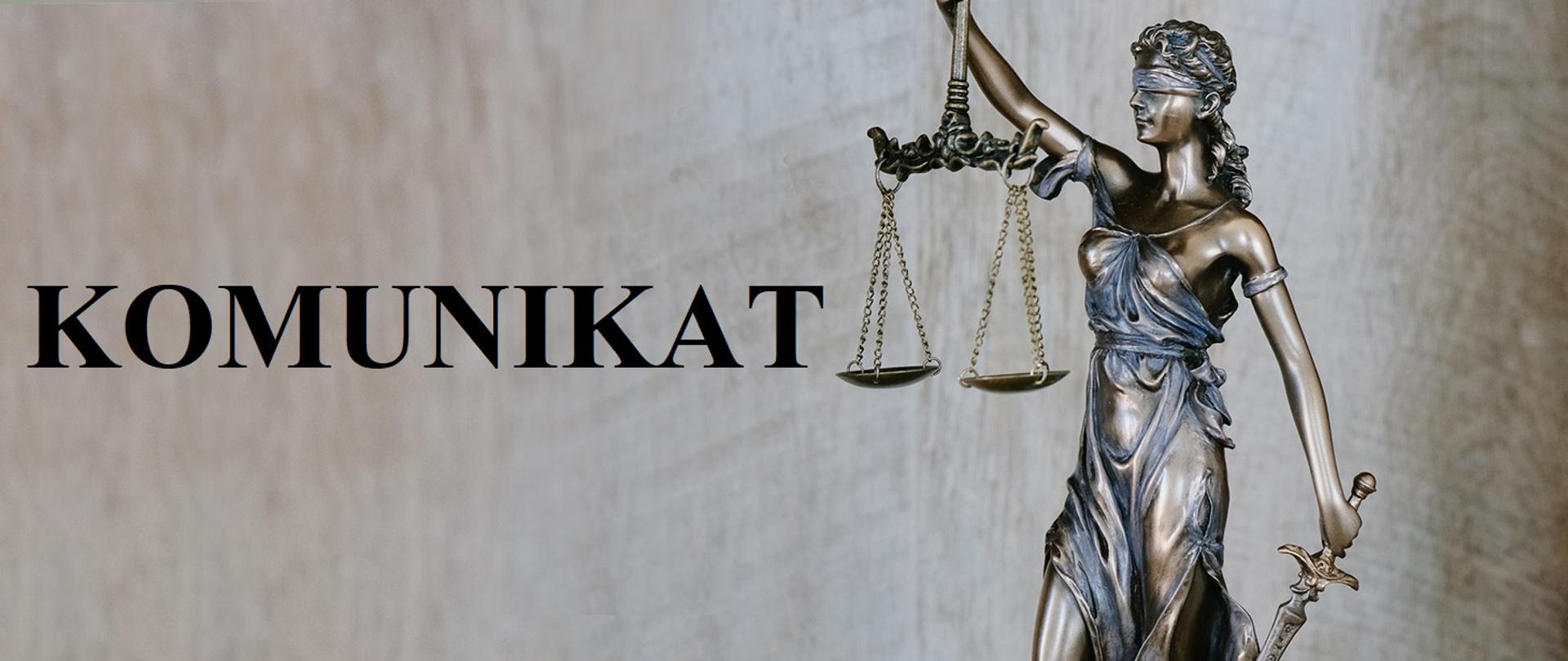 Obrazek z figurką Temidy w tle