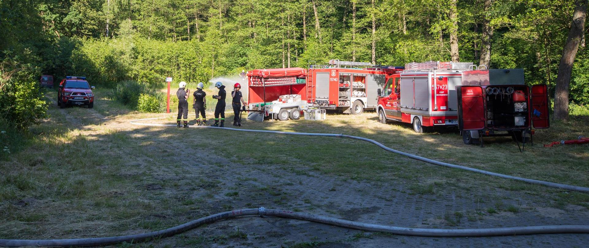 Na zdjęciu widać pojazdy pożarnicze oraz strażaków podczas ćwiczeń modułu wodnego Piła.