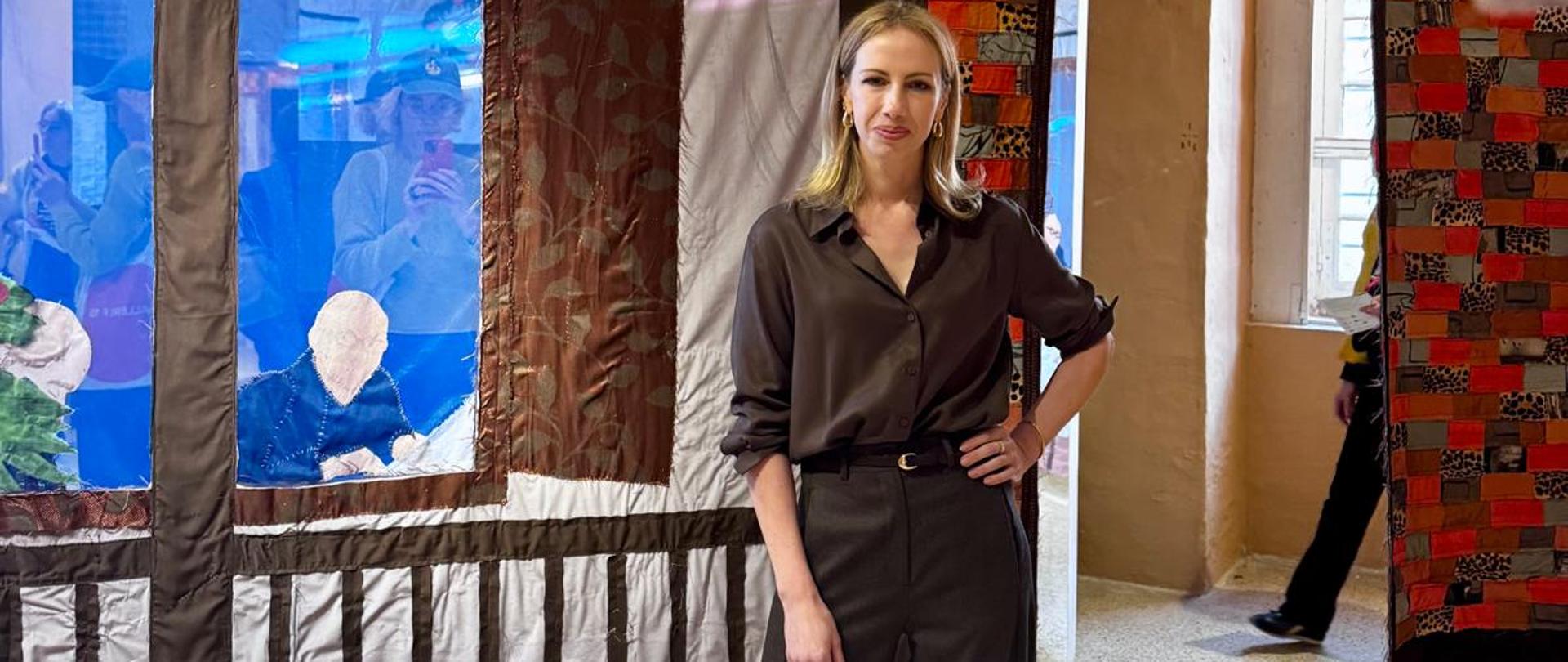 In the middle of one of the rooms in the thematic pavilion, the pavilion's curator poses for a photo.