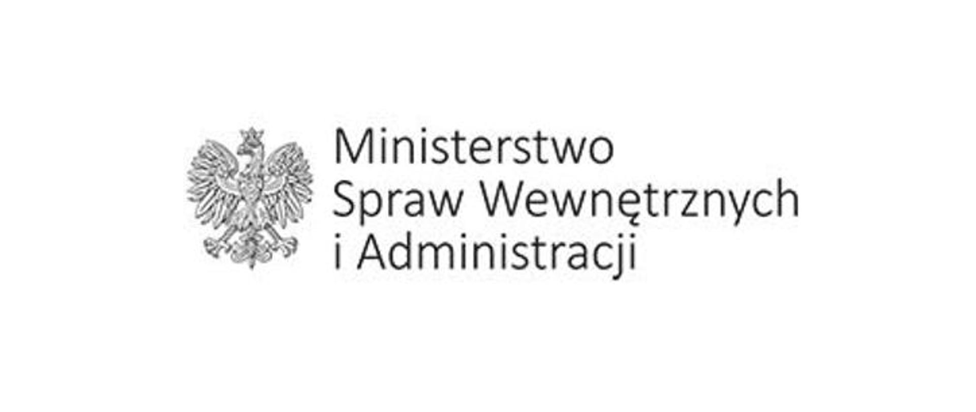 Zdjęcie przedstawia białego orła w koronie znajdującego się w godle Polski. Po prawej stronie orła znajduje się czarny napis Ministerstwo Spraw Wewnętrznych i Administracji