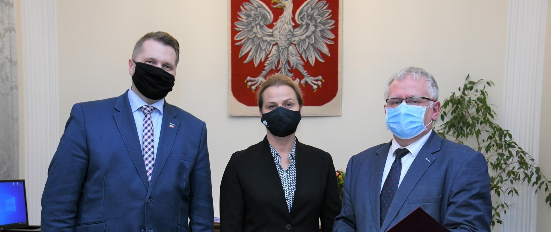 Minister Czarnek wręcza informację o przyznaniu dotacji.