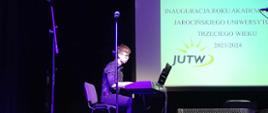 Zdjęcie przedstawia ucznia grającego na pianinie podczas koncertu dla UTW w Jarocinie.