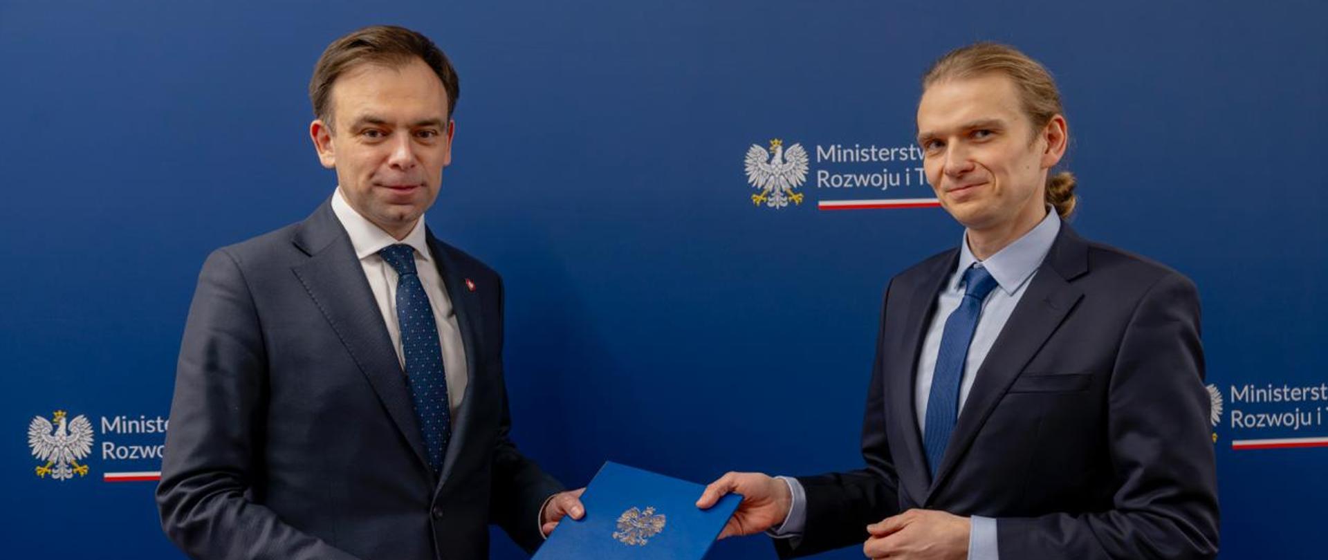 Minister finansów i gospodarki Andrzej Domański wręcza nominację Janowi Kuzawińskiemu na kolejną kadencję na stanowisku Prezesa Krajowej Izby Odwoławczej. 