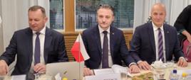 Na zdjęciu widać zastępcę komendanta głównego PSP nadbryg. Adama Koniecznego, Bartosza Grodeckiego podsekretarza stanu w MSWIA oraz Dariusza Nowaka dyrektora generalnego MSWiA siedzących przy stole konferencyjnym w czasie wizyty w Helsinkach 
