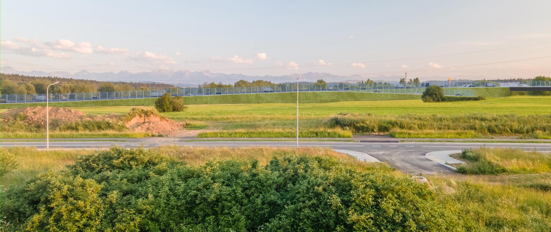 wizualizacja przebiegu obwodnicy Nowego Targu z osiedla Polana Szaflarska - na zdjęciu widoczna grafika przyszłej drogi naniesiona na zdjęcie 