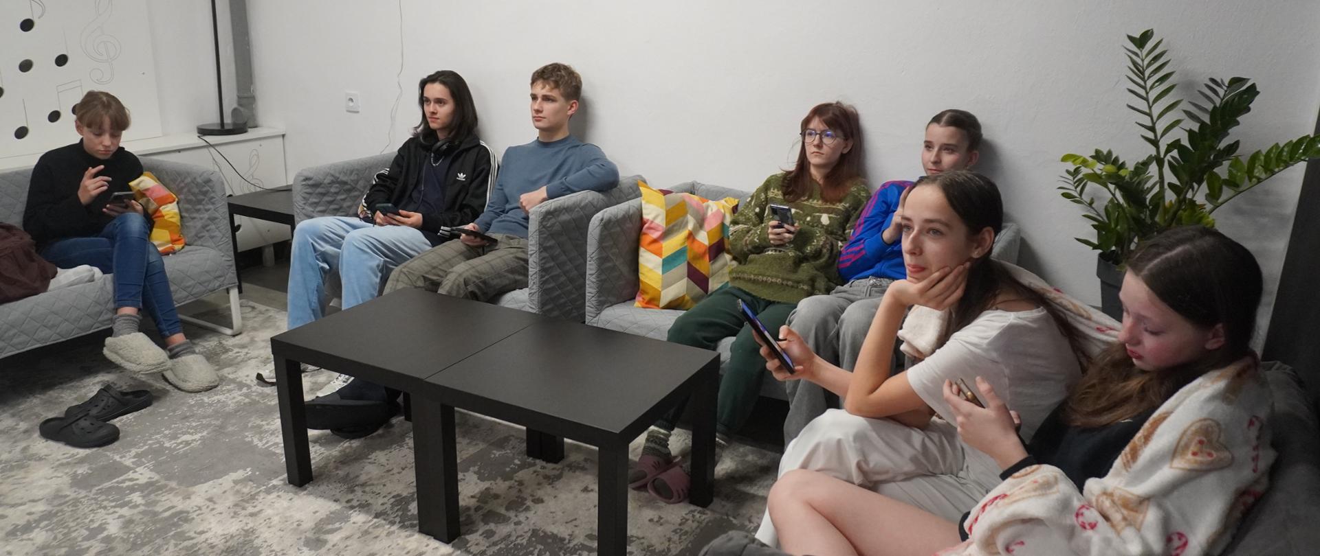 Wychowankowie zaznaczają odpowiedzi w swoich telefonach 