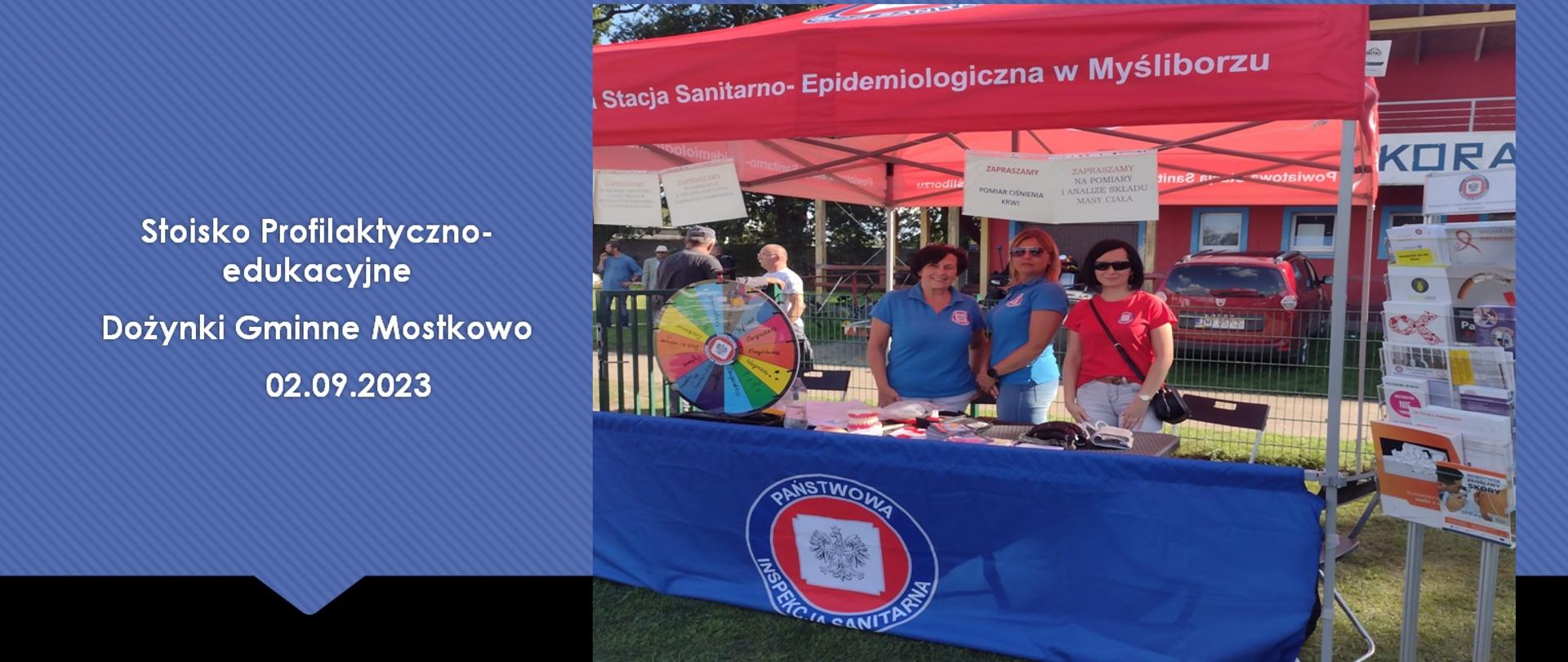 Na fotografii widać pracowników Sanepidu przy stoisku dożynki z kołem fortuny.