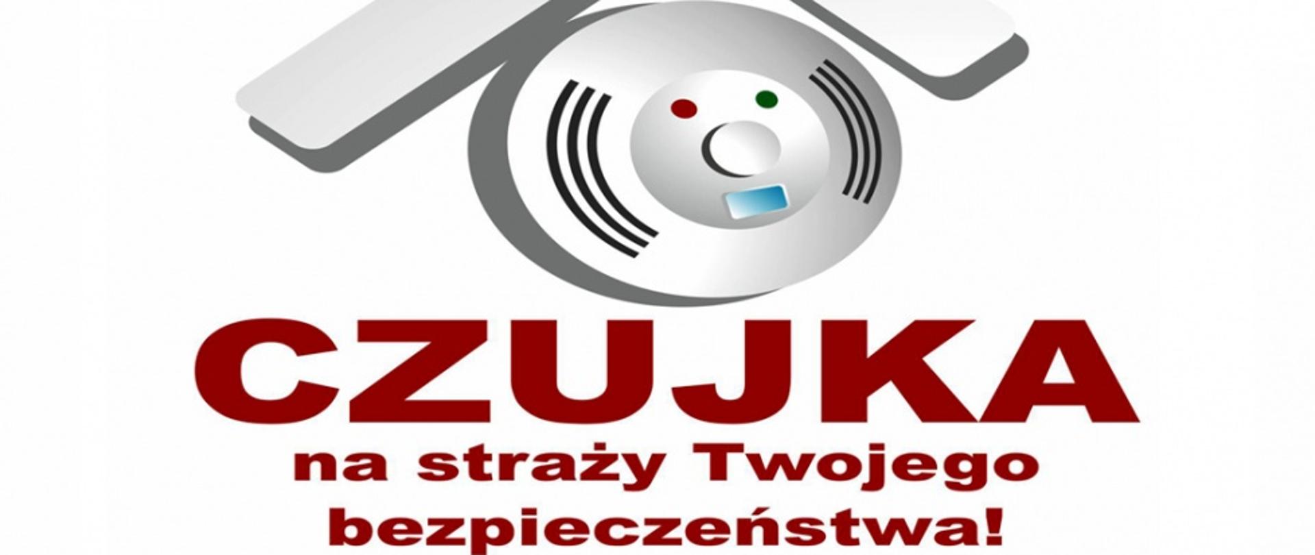 Na zdjęciu widoczny rysunek dachu domu w środku czuja i napis na białym tle czujka na straży Twojego bezpieczeństwa!. 