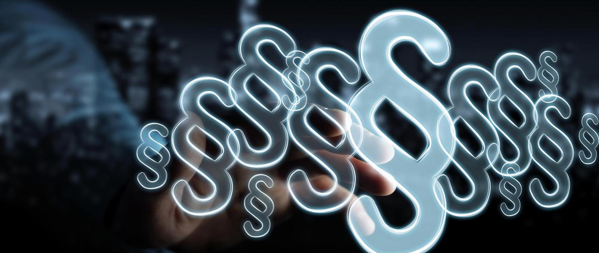 Przezroczyste paragrafy, za którymi widoczna jest dłoń.