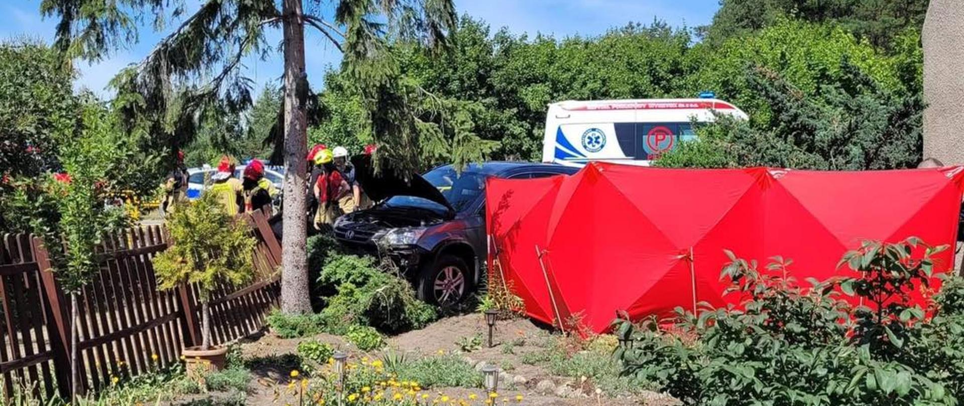 Zdjęcie przedstawia samochód osobowy po wypadku drogowym-uderzenie w płot. 