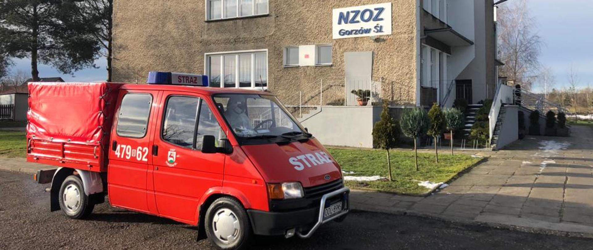 Samochód strażacki w tle budynek przychodni NZOZ