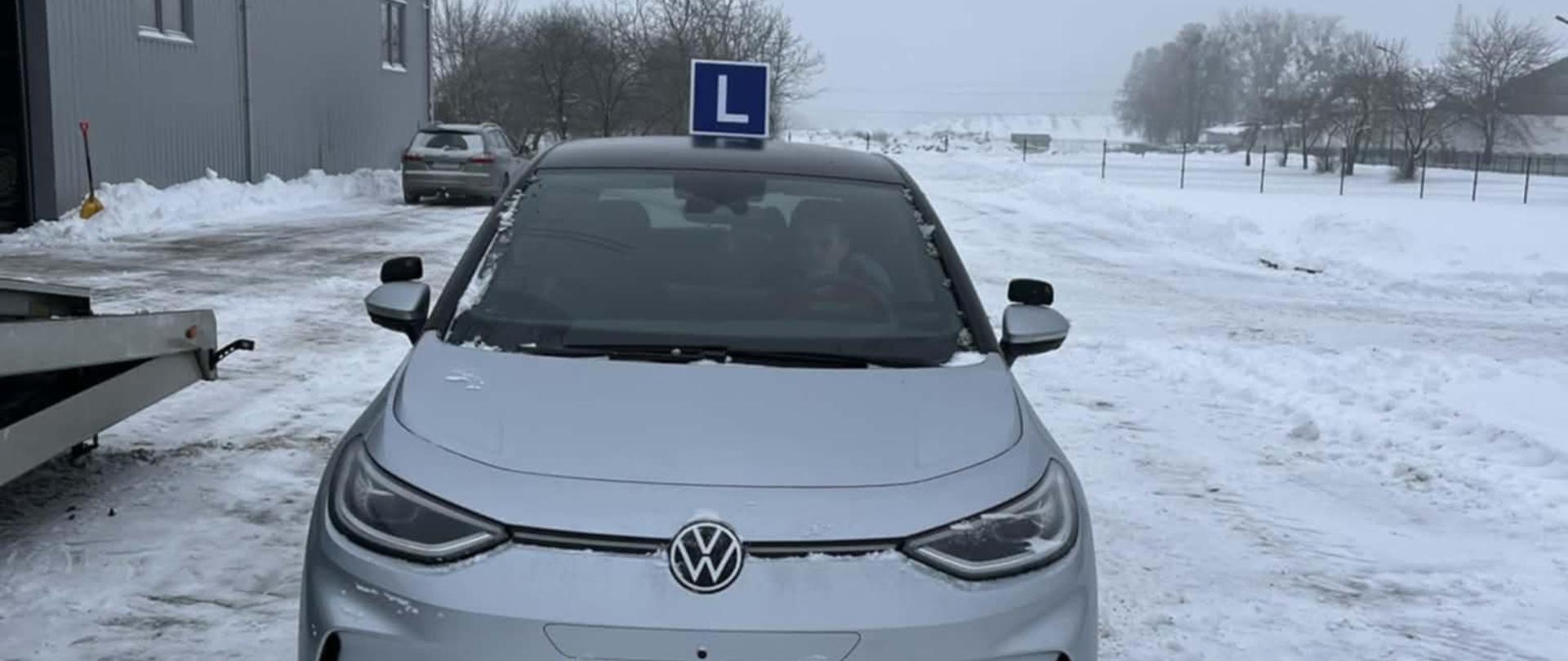 Elektryczny samochód Volkswagen ID.3 przeznaczony do nauki jazdy, na ośnieżonym placu