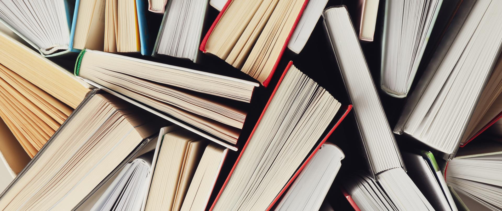 Many books textured background, top view. Multicolored books