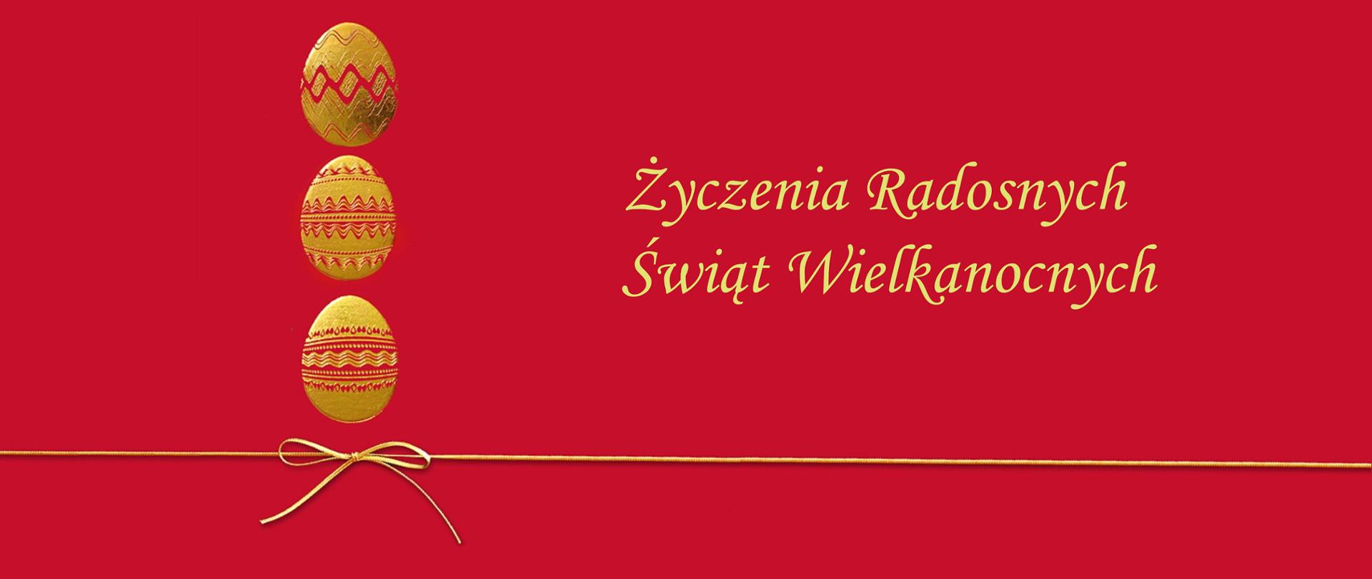 czerwona grafika trzy złote jajka umieszczone w pionie, pod jajkami wstążka na całej szerokości, po prawej napis Życzenia Radosnych Świąt Wielkanocnych