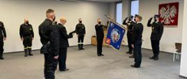 na zdjęciu komendant powiatowy przeprowadza ślubowanie strażaków w obecności sztandaru komendy oraz strażaków zmiany służbowej
