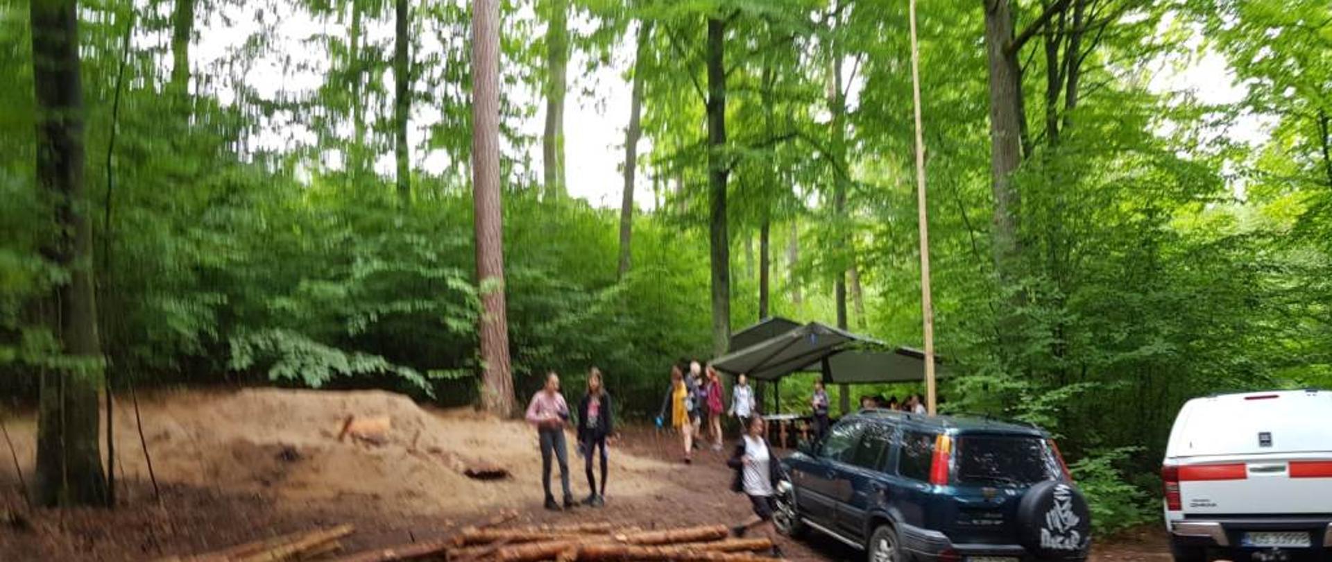 Obóz harcerski, w tle harcerze, samochód pożarniczy.