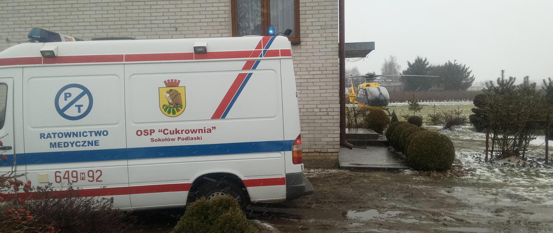 Ambulans i śmigłowiec przy domu mieszkalnym. 