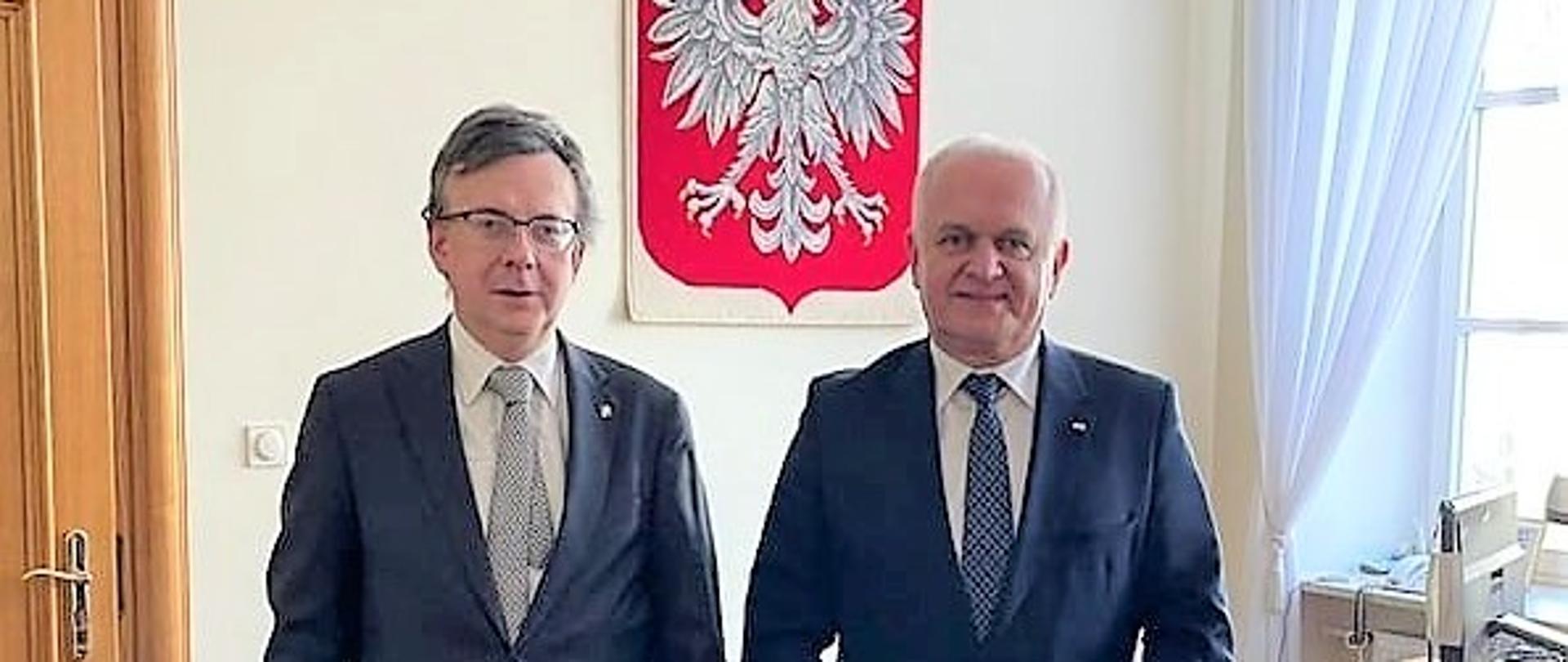 Wojewoda Władysław Dajczak i Szef Służby Cywilnej Dobrosław Dowiat-Urbański pozują do wspólnego zdjęcia na tle biurka 