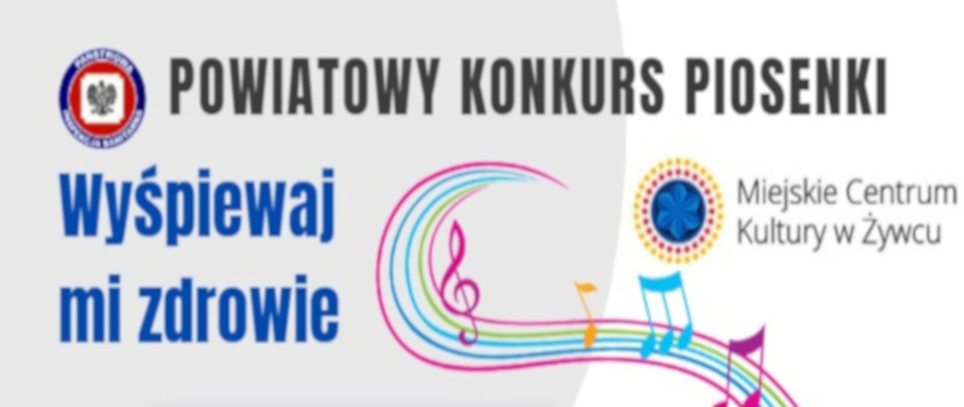 baner ogłaszający lokalny konkurs piosenki. W górnej części znajduje się białe tło z logo Państwowej Inspekcji Sanitarnej. Tekst głosi: "POWIATOWY KONKURS PIOSENKI" w większej czcionce i "WYŚPIEWAJ MI ZDROWIE" w mniejszej czcionce poniżej. Na dole jest napis "Miejskie Centrum Kultury w Żywcu". W centralnej części grafiki przeplatają się kolorowe linie przypominające strumień nut i klucz wiolinowy, co sugeruje tematykę muzyczną. Kolorystyka to głównie odcienie różu, niebieskiego i żółtego na białym tle. W prawym dolnym rogu znajduje się niebieska rozeta lub kwiat, dodając grafice artystycznego akcentu.
