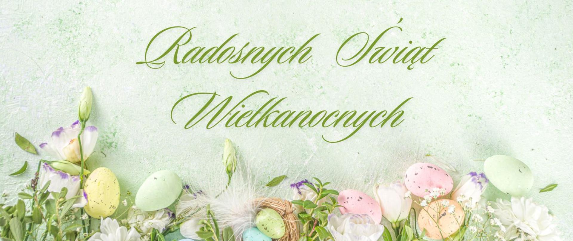 Grafika zawierająca kolorowe jajka, białe kwiaty i zielone listki, nad nimi napis "Radosnych Świąt Wielkanocnych"