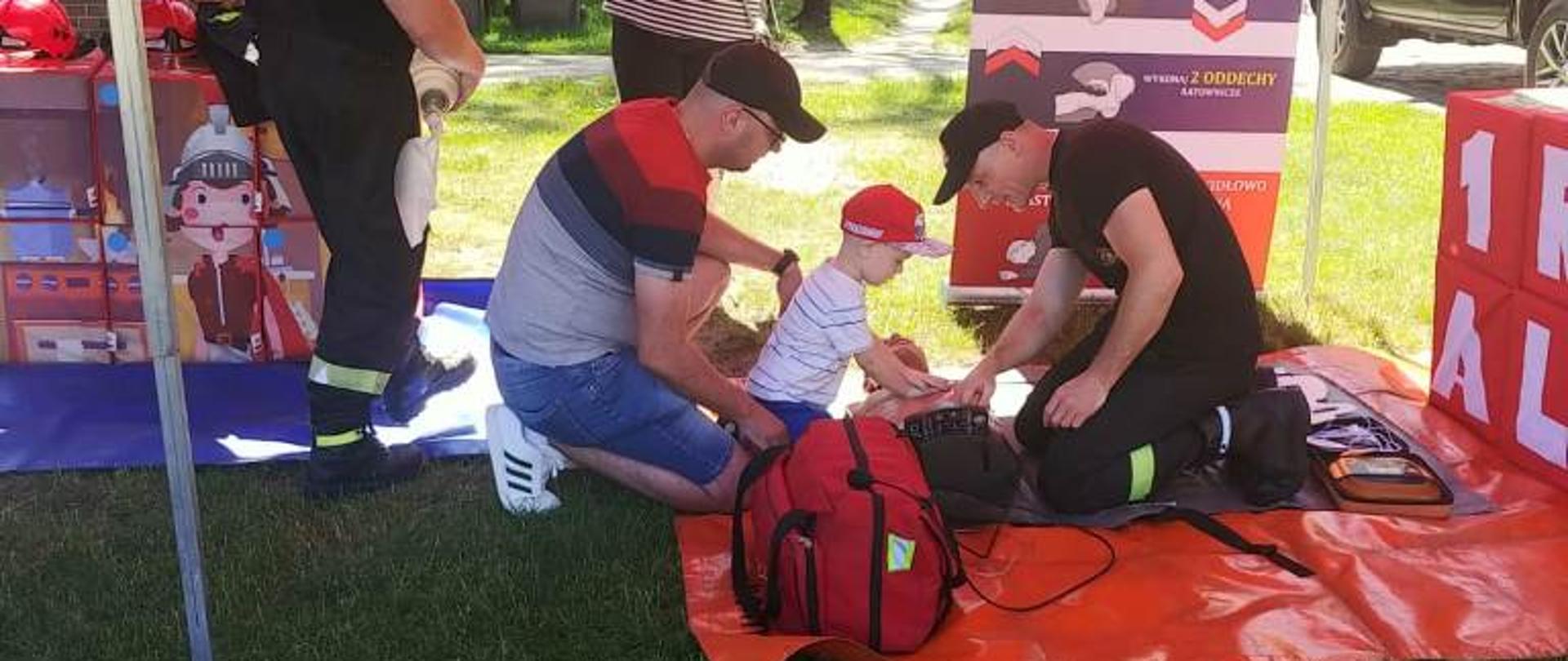 Chłopiec uczy się robić sztuczne oddychanie. 