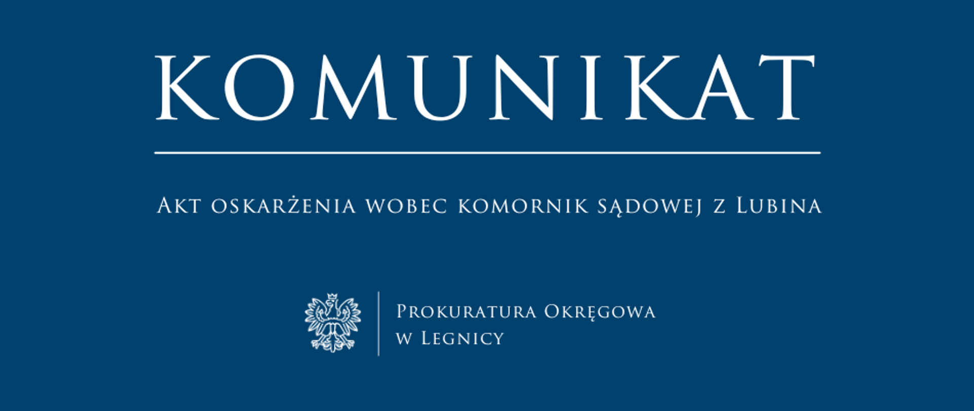 baner - na niebieskim tle napis w kolorze białym Komunikat, poniżej pozioma biała kreska, pod kreską napis "Akt oskarżenia wobec komornik sądowej z Lubina", niżej pośrodku rysunek orła oddzielony od napisu Prokuratura Okręgowa w Legnicy krótką pionową kreską