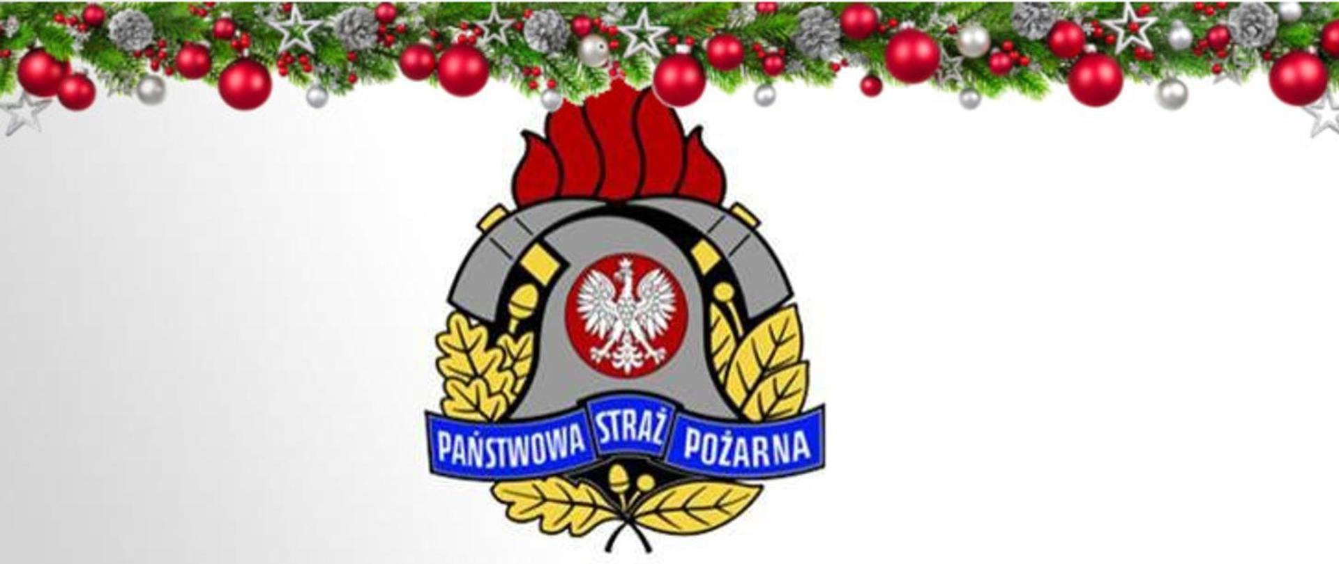 Zdjęcie przedstawia logo Państwowej Straży Pożarnej ustrojone na górze ozdobami świątecznymi