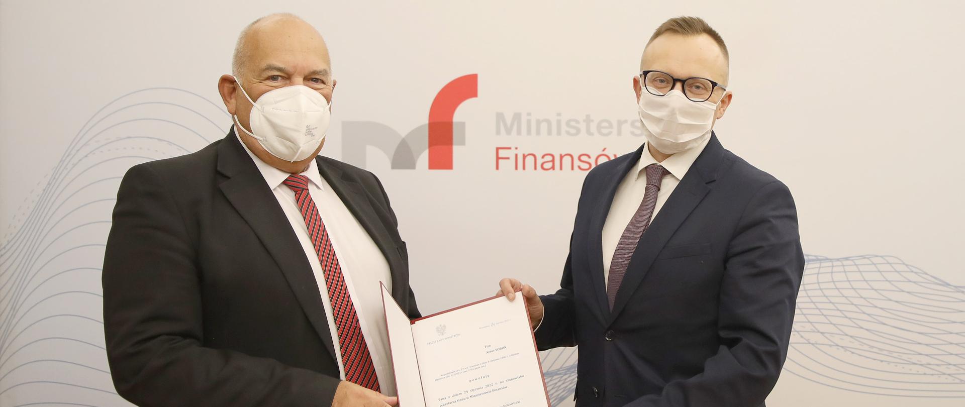 Minister Tadeusz Kościński i wiceminister Artur Soboń na tle banera MF