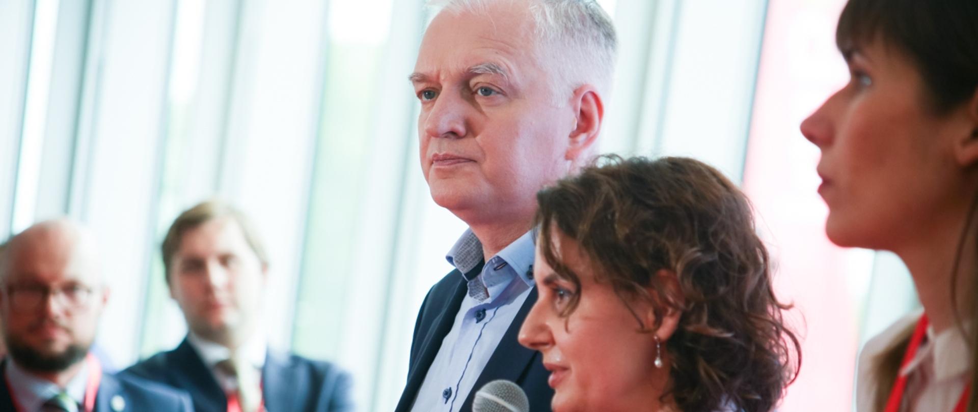 Minister Jarosław Gowin stoi na tle okna