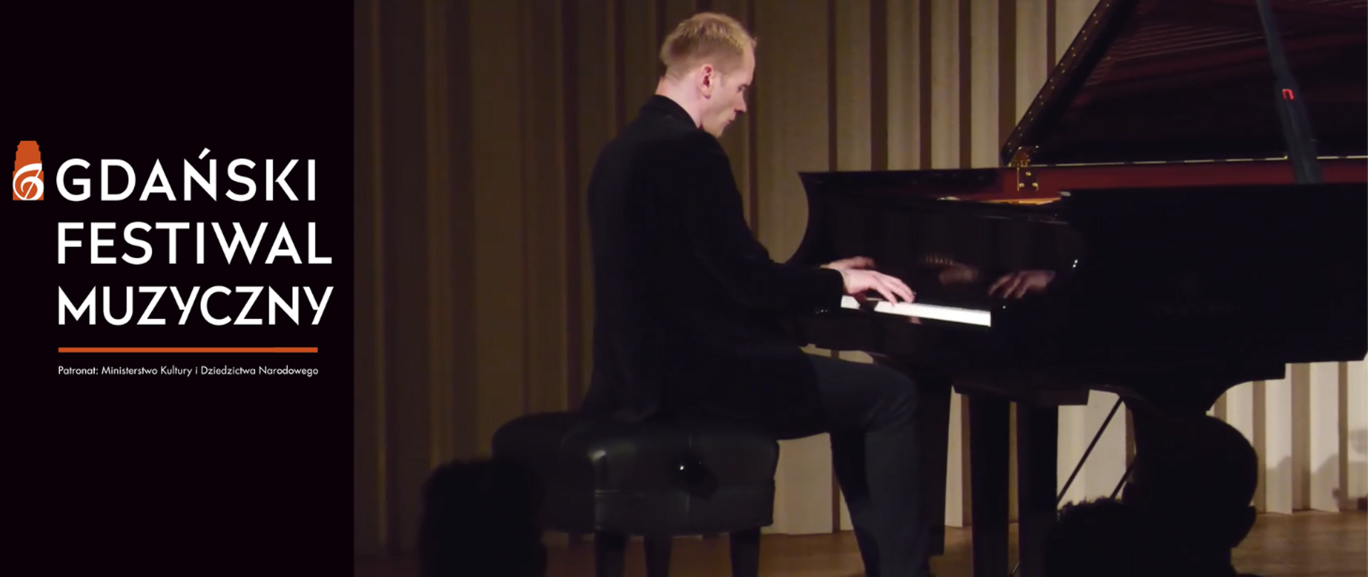 Tło obrazka w kolorze czarnym. Po lewej stronie biały napis: "Gdański Festiwal Muzyczny". Poniżej pod pomarańczową kreską informacja białą czcionką: "Patronat: Ministerstwo Kultury i Dziedzictwa Narodowego" . Po prawej stronie w czarnym garniturze mężczyzna o blond włosach gra na czarnym fortepianie.