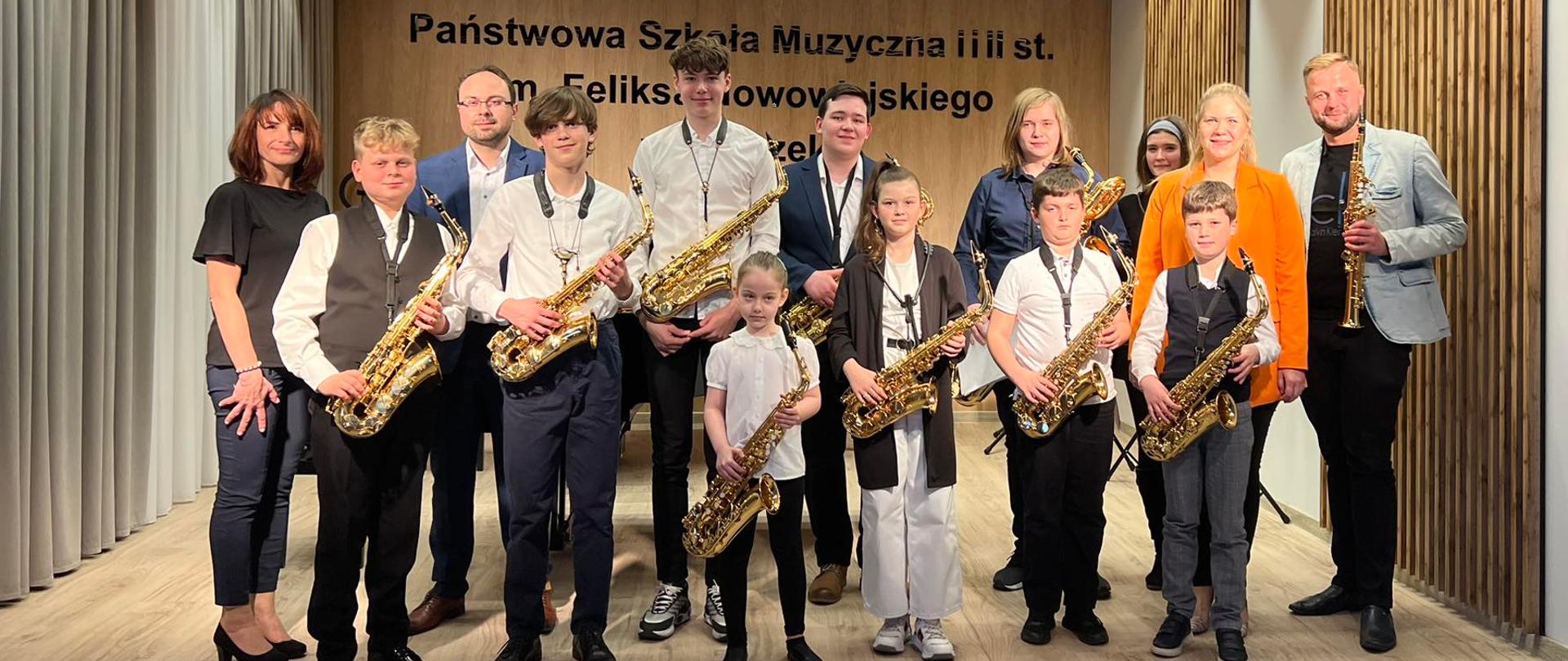 Zdjęcie przedstawiające wszystkich wykonawców kwietniowego koncertu saksofonowego w auli Szkoły Muzycznej w Zgorzelcu w dniu 26.04.2023 r.