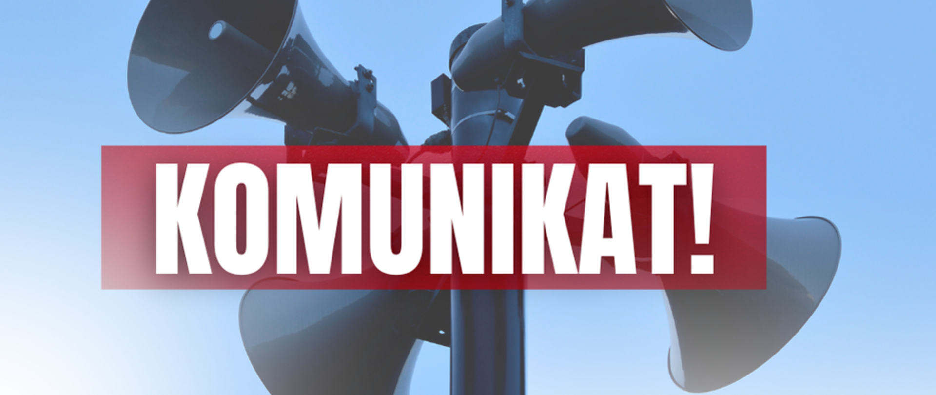 Obraz przedstawia syreny alarmowe na tle, których widnie biały napis: "KOMUNIKAT!" na czerwonym prostokątnym pasie