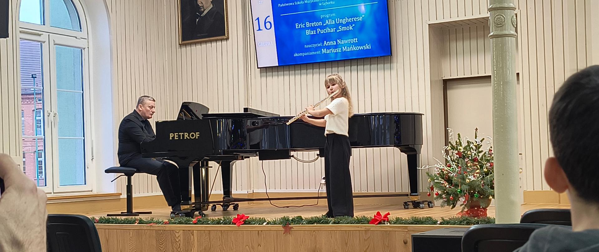 Zdjęcie. Na scenie akompaniator przy fortepianie i flecistka podczas gry.