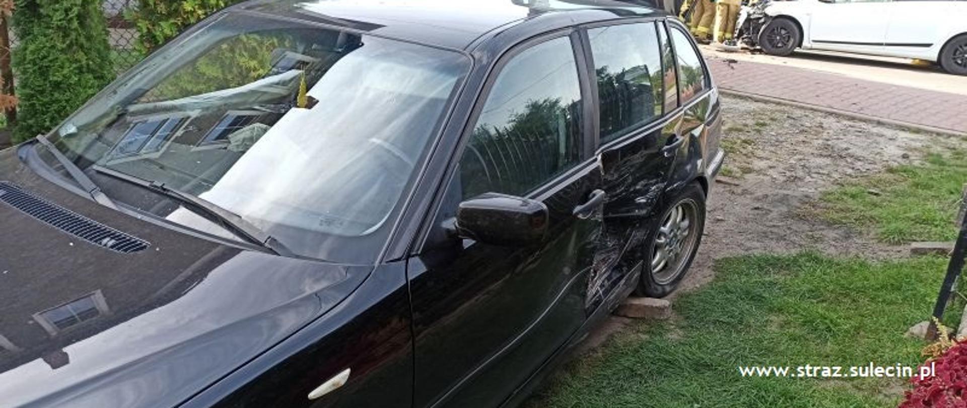 Na zdjęciu widać czarny pojazd osobowy- lewa tylna część jest wgnieciona