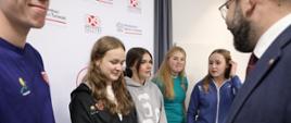 Minister Grzegorz Puda wita się z młodzieżą Szkoły Mistrzostwa Sportowego Rekord w Bielsku-Białej, minister ściska dłoń uczennicy szkoły